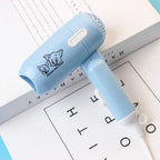 Mini foldable cartoon-style hair dryer in blue color – compact travel blow dryer with cold and hot air settings