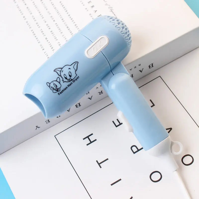 Mini foldable cartoon-style hair dryer in blue color – compact travel blow dryer with cold and hot air settings