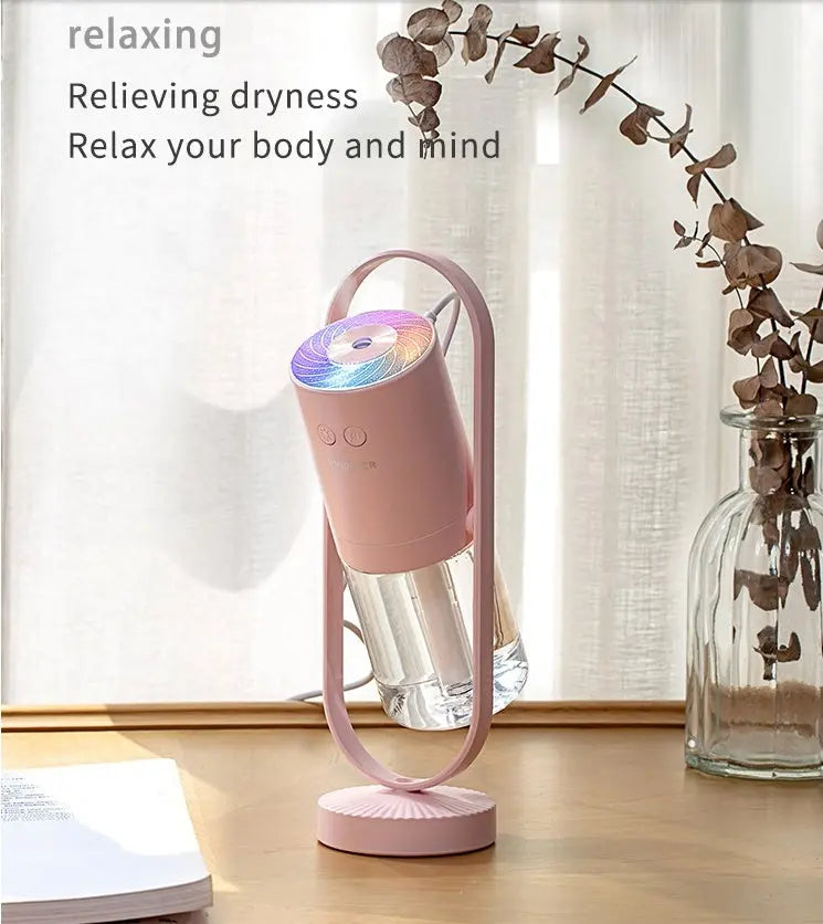 Pink humidifier on a wooden surface with text about relaxing and relieving dryness.