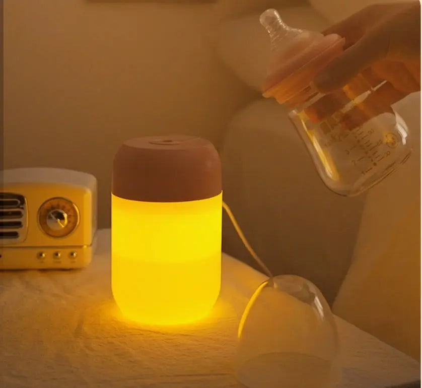 Luminous night light on a surface with a bottle in the background