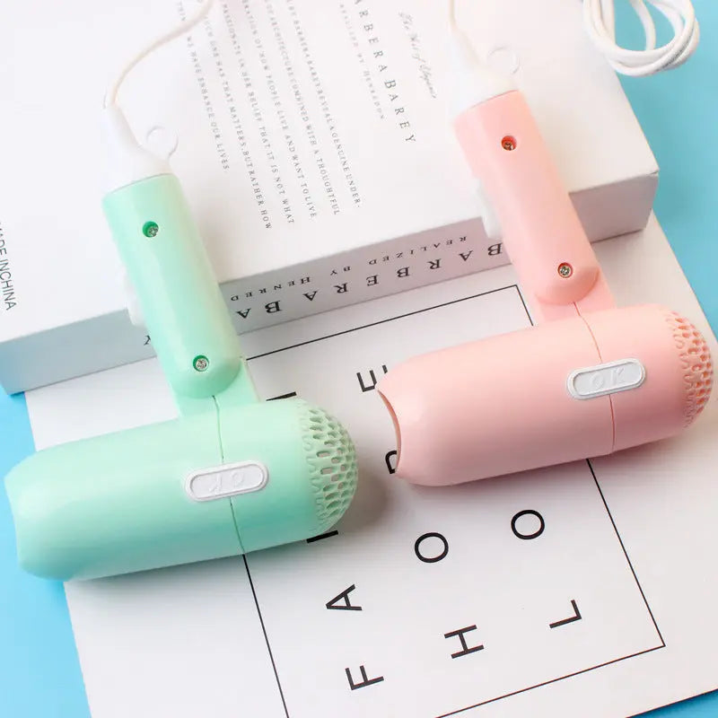 Mini foldable cartoon-style hair dryer in pastel colors – compact travel blow dryer with cold and hot air settings