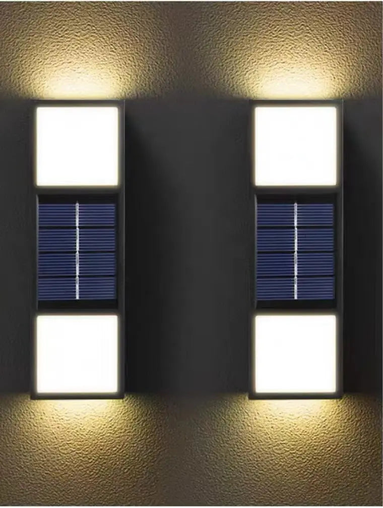 Two solar wall lights on a textured wall