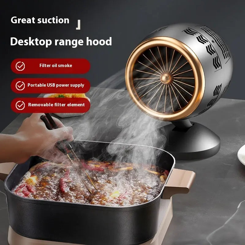 Portable small kitchen ventilator in black gold with filter element, USB-powered desktop smoke extractor fan