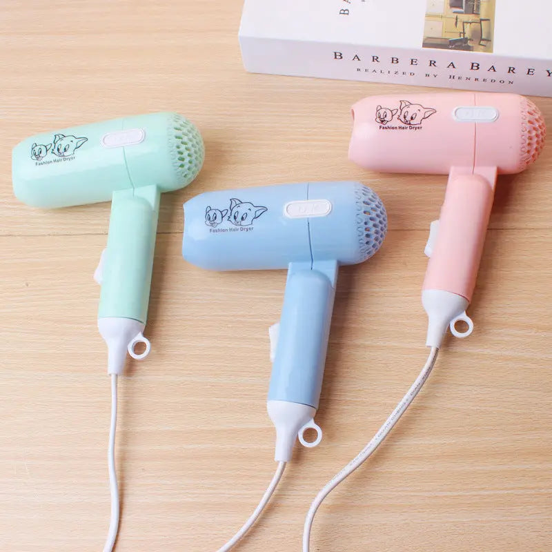 Mini foldable cartoon-style hair dryer in pastel colors – compact travel blow dryer with cold and hot air settings

