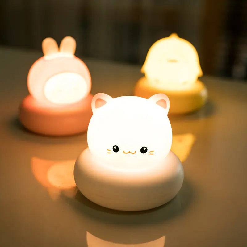 LED bedside desk lamp with cute pet designs (rabbit, kitten, duckling, bear), tap-controlled light, and modern style for home decoration